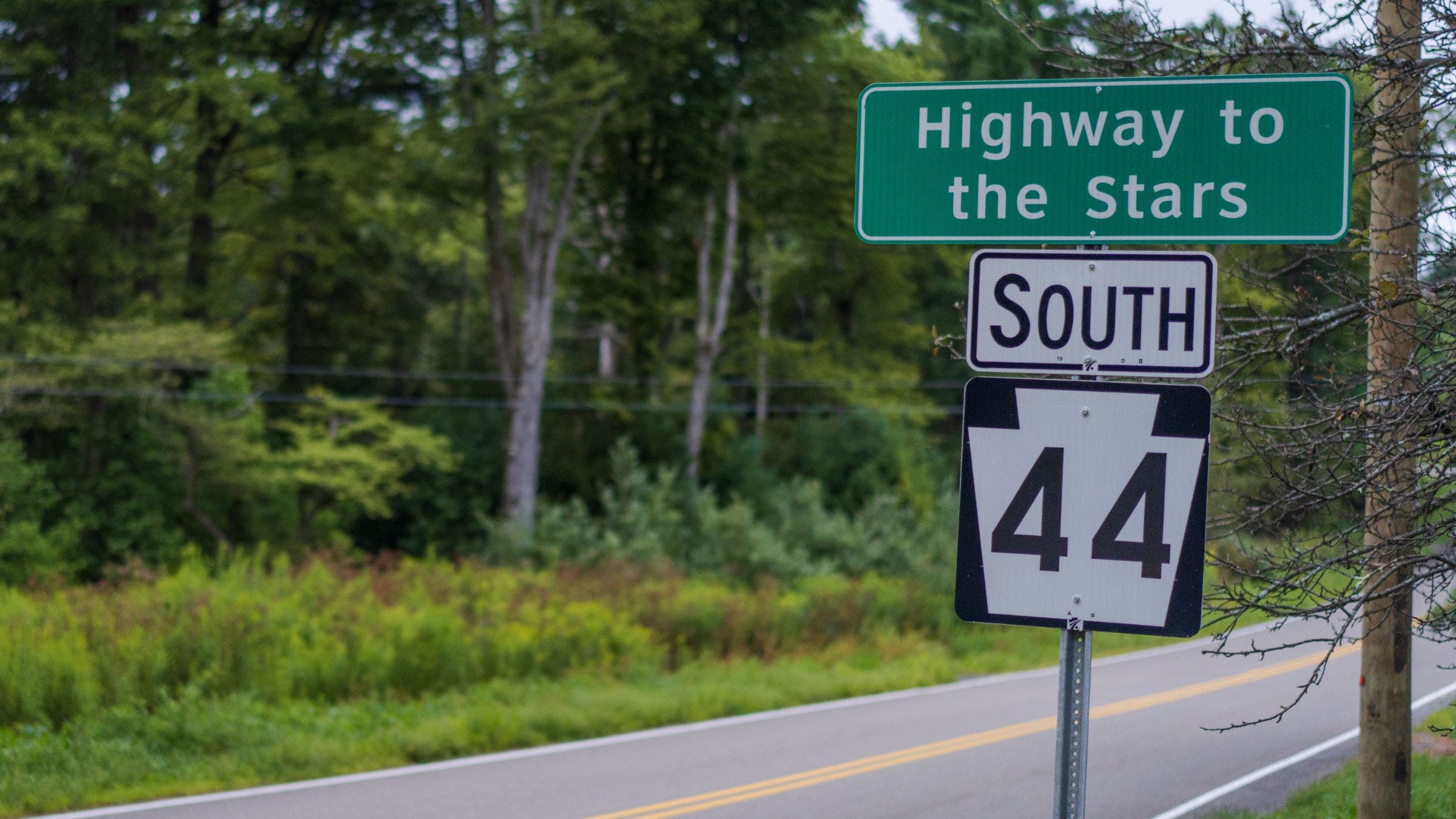 sign on road that reads "Highway to the Stars"